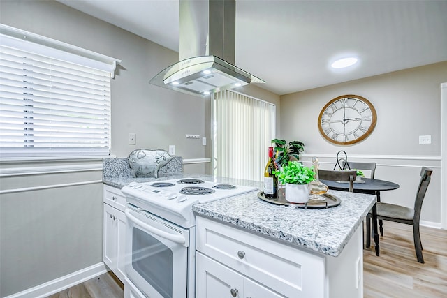 kitchen featuring light hardwood / wood-style flooring, white cabinets, a healthy amount of sunlight, white electric stove, and island range hood