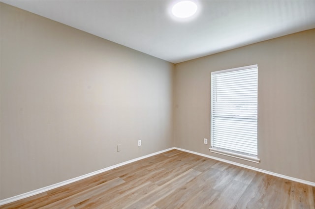 spare room with wood-type flooring