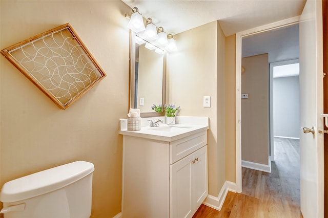 bathroom featuring hardwood / wood-style flooring, vanity, and toilet