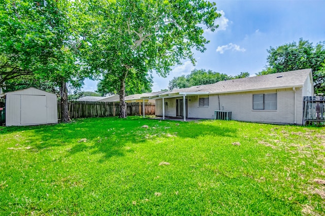 view of yard with a storage shed and central AC unit