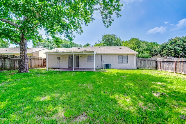 back of property featuring a lawn