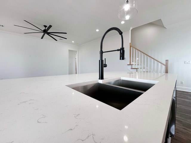 interior space featuring ceiling fan, sink, ornamental molding, and hardwood / wood-style flooring