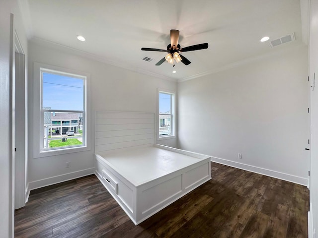 unfurnished bedroom featuring ceiling fan, crown molding, and dark hardwood / wood-style flooring