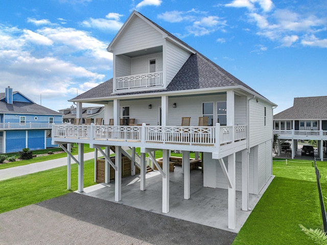 exterior space featuring a lawn, a garage, and a balcony