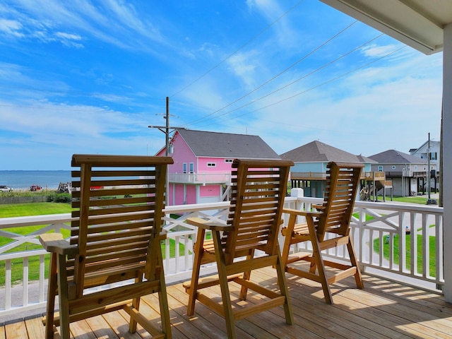 wooden terrace featuring a water view