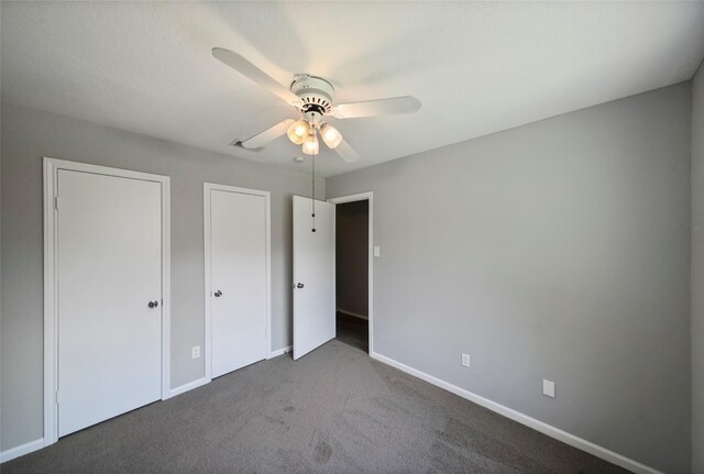 unfurnished bedroom featuring ceiling fan and carpet floors