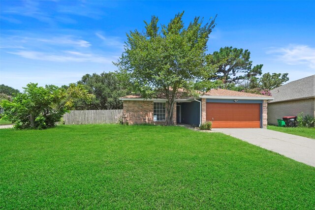 ranch-style house featuring a garage and a front yard