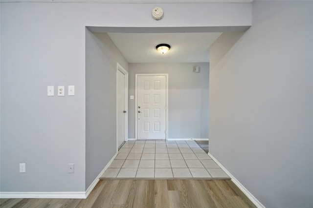 corridor with light wood-type flooring