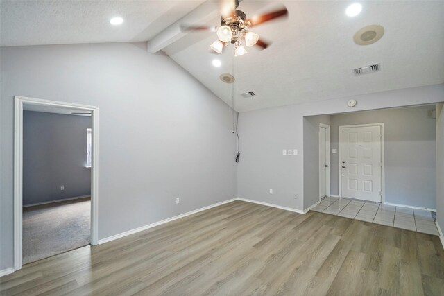 empty room featuring carpet floors, lofted ceiling with beams, and ceiling fan