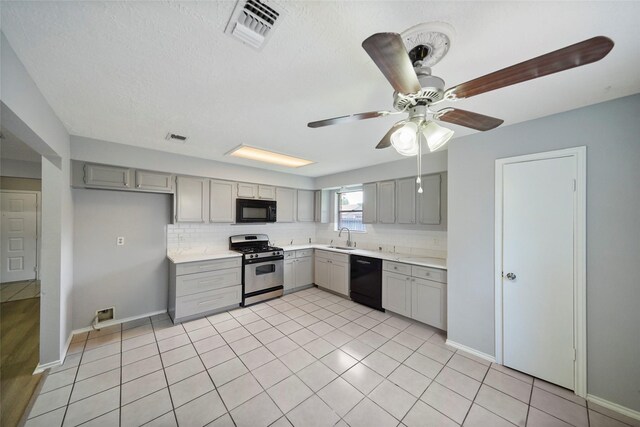 kitchen featuring sink, black appliances, ceiling fan, light tile patterned flooring, and gray cabinets