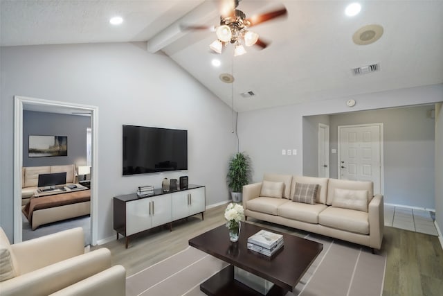 living room with ceiling fan, light hardwood / wood-style floors, and lofted ceiling with beams