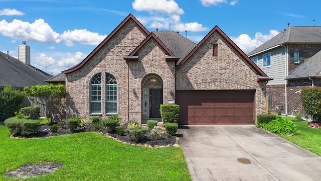 view of front of home with a front lawn and a garage