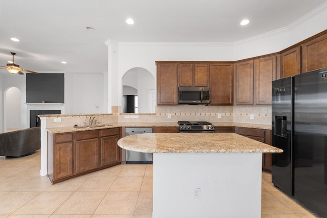 kitchen featuring ceiling fan, decorative backsplash, stainless steel appliances, and light tile patterned floors