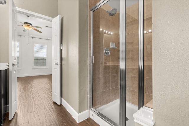 bathroom with ceiling fan, an enclosed shower, vanity, and wood-type flooring