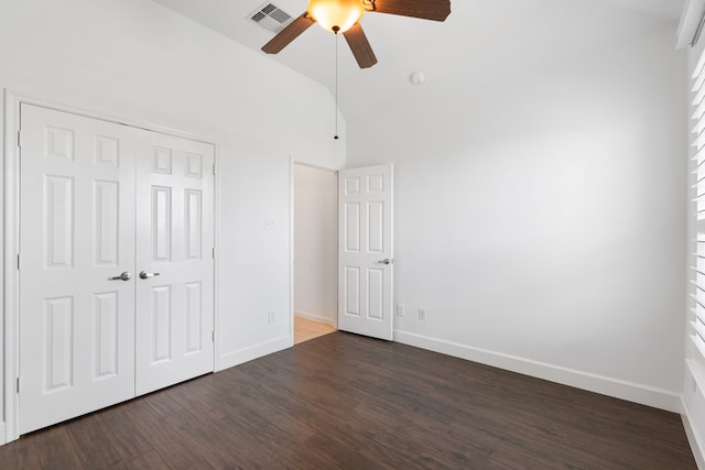 unfurnished bedroom featuring ceiling fan, high vaulted ceiling, a closet, and wood-type flooring