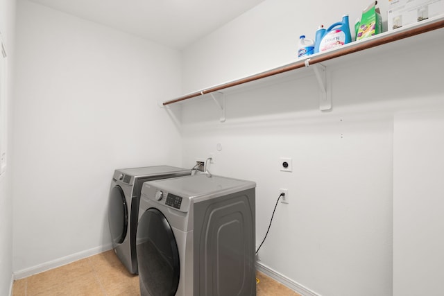 laundry area with light tile patterned flooring and separate washer and dryer