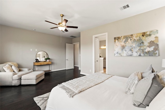 bedroom with ensuite bath, ceiling fan, and dark hardwood / wood-style flooring