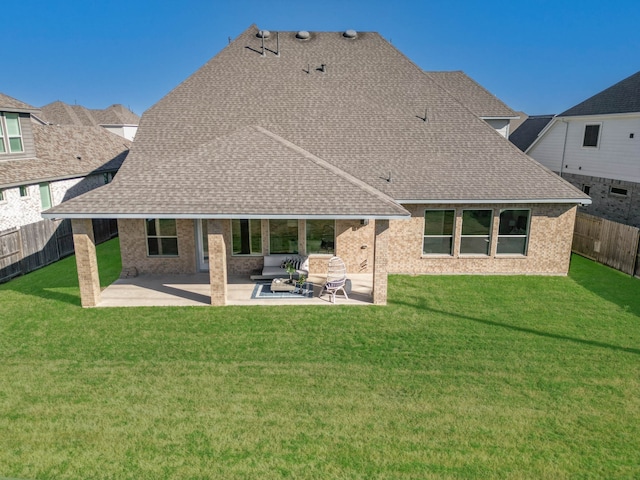 back of house with a yard, a patio, and an outdoor hangout area