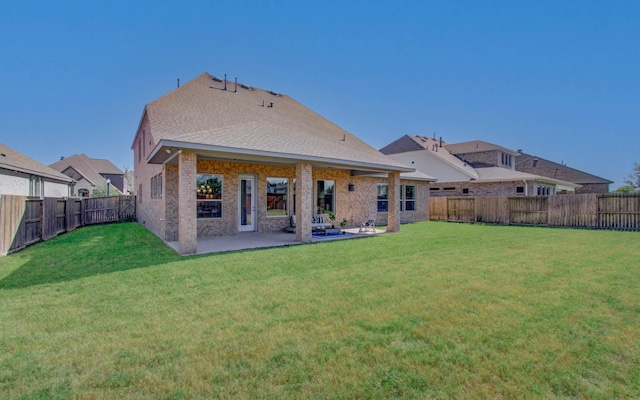 back of house featuring a patio area and a yard