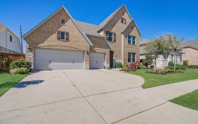 view of front of property with a garage and a front lawn