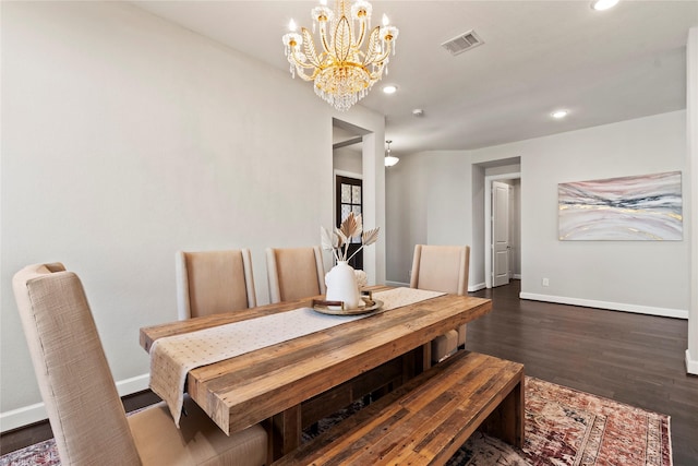 dining room featuring dark hardwood / wood-style floors and an inviting chandelier