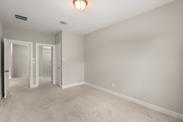 unfurnished bedroom with light colored carpet