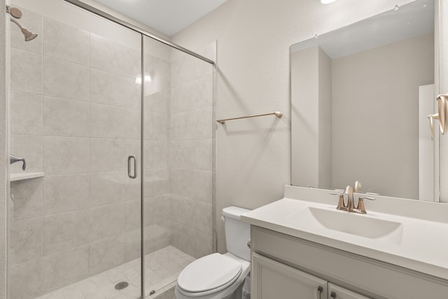 bathroom with vanity, an enclosed shower, and toilet