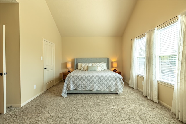 bedroom with lofted ceiling and light carpet