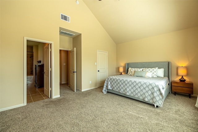 carpeted bedroom with ensuite bath and high vaulted ceiling