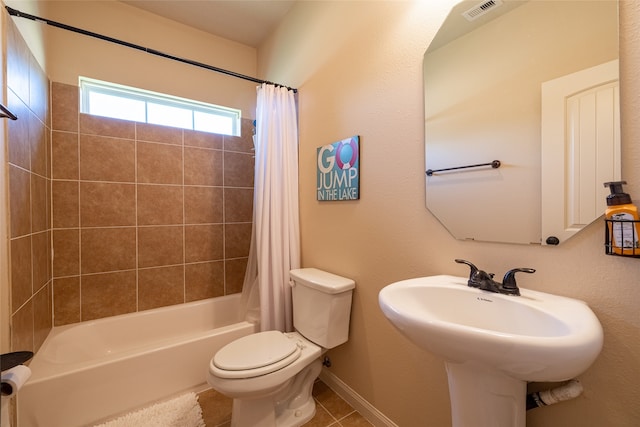 bathroom featuring shower / bath combo, tile patterned flooring, and toilet