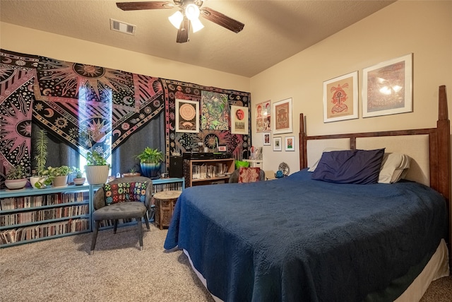 carpeted bedroom featuring ceiling fan and a textured ceiling