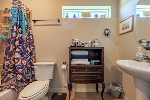 bathroom with toilet and tile patterned flooring