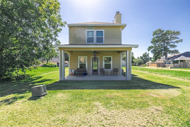 back of property featuring a patio area, a yard, and ceiling fan