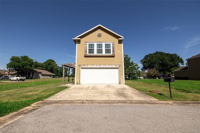 view of property featuring a front yard and a garage