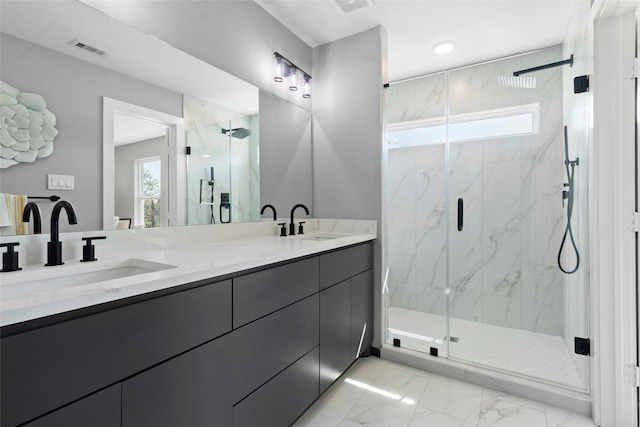 bathroom with vanity and a shower with door