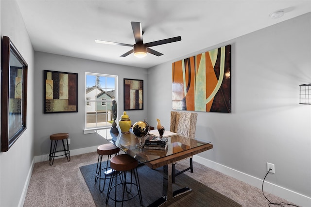 carpeted dining area featuring ceiling fan