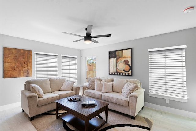 living room with ceiling fan and light hardwood / wood-style flooring