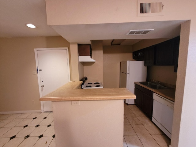 kitchen featuring sink, white appliances, and light tile patterned floors