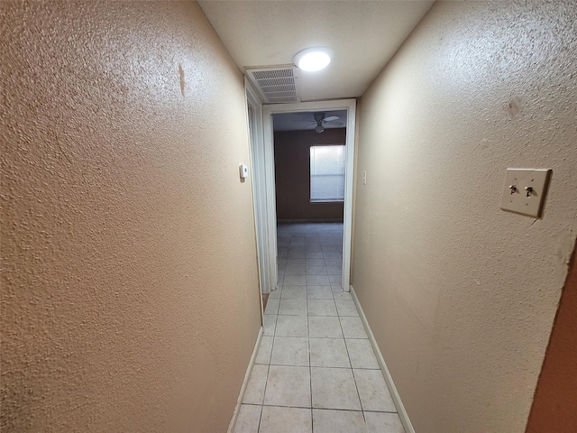 hall featuring light tile patterned flooring