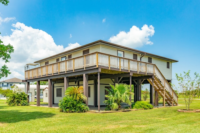 back of property with a wooden deck and a lawn