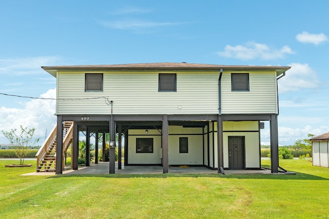 back of property featuring a patio and a yard