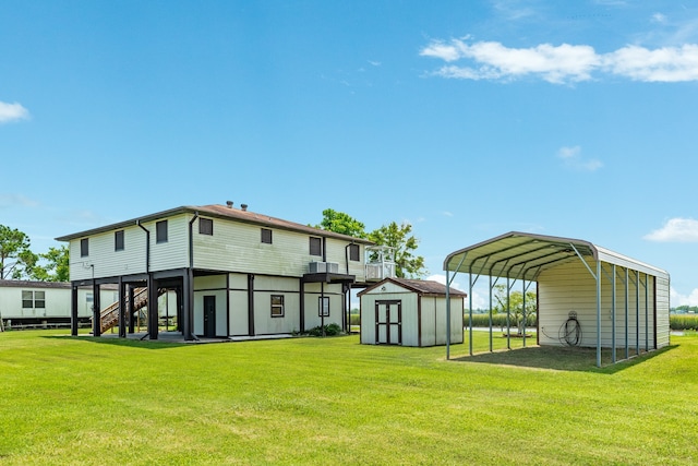 rear view of house with a carport, a yard, and a storage shed