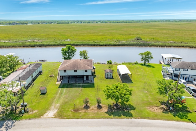 bird's eye view with a water view and a rural view