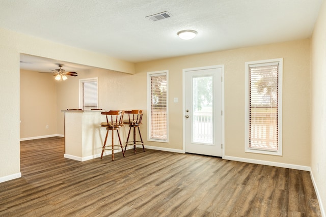 entrance foyer with ceiling fan, wood-type flooring, and a textured ceiling