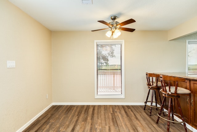 dining area with ceiling fan and hardwood / wood-style floors