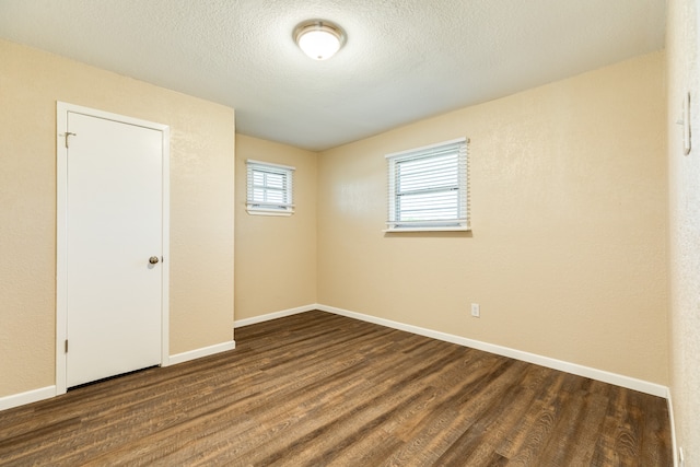 unfurnished bedroom with wood-type flooring, a textured ceiling, and a closet