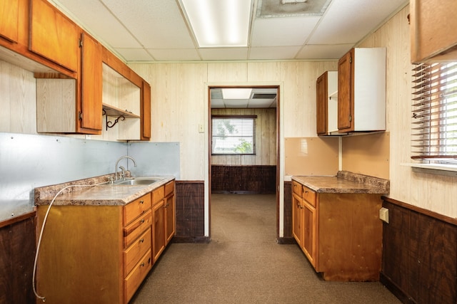 kitchen with dark colored carpet, a drop ceiling, and sink