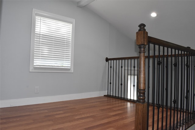 interior space featuring vaulted ceiling with beams and hardwood / wood-style flooring