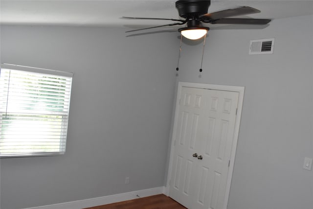 empty room with ceiling fan and wood-type flooring