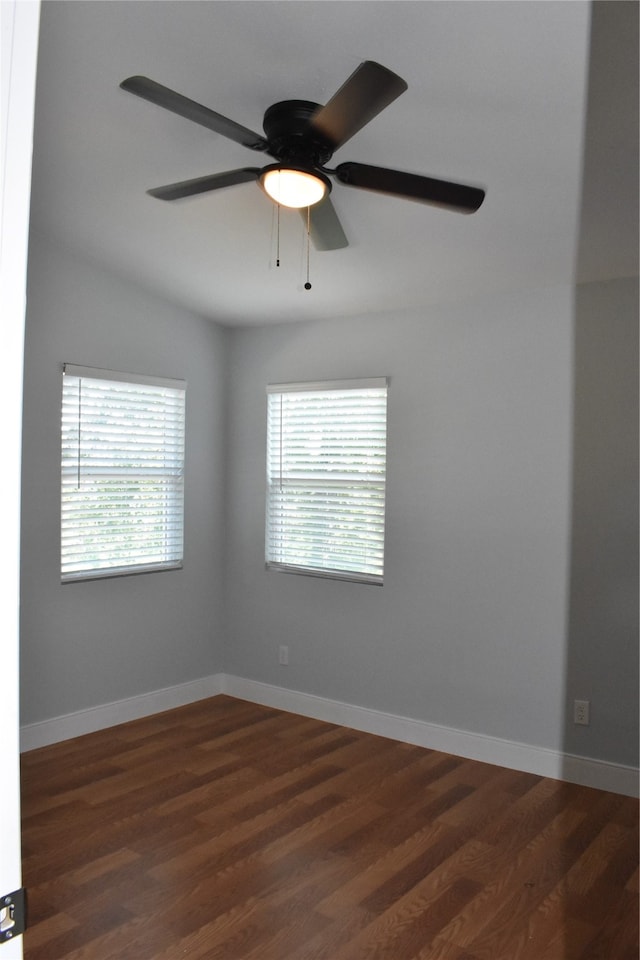 empty room with ceiling fan, dark wood-type flooring, and lofted ceiling